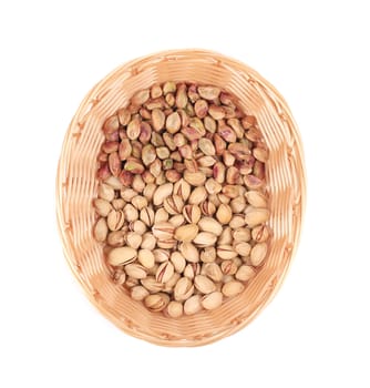 Wicker basket with pistachios. Isolated on a white background.