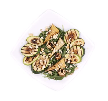 Salad with grilled vegetables and tofu. Isolated on a white background.
