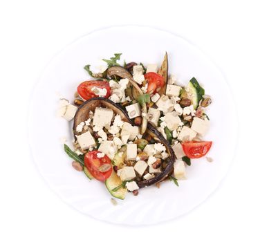 Salad with grilled vegetables and tofu. Isolated on a white background.