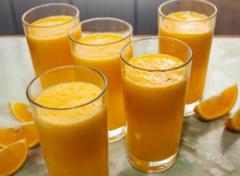 glasses of orange juice and fruits