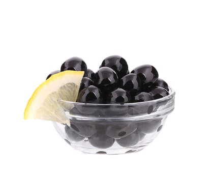 Black olives in a bowl. Isolated on a white background.