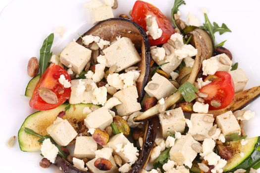 Salad with grilled vegetables and tofu. Whole background.