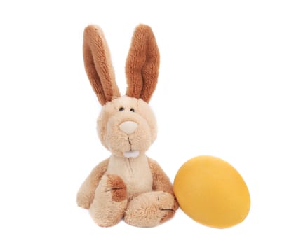 Easter rabbit with yellow egg. Isolated on a white background.