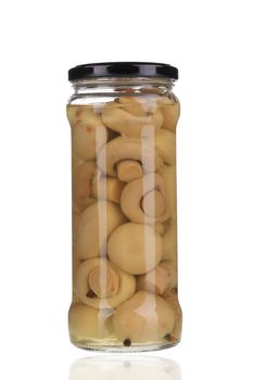 Marinated champignon mushrooms in glass jar. Isolated on a white background.