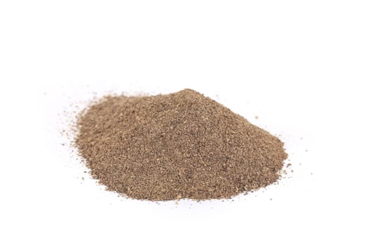 Pile of ground pepper. Isolated on a white background.