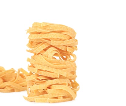 Tagliatelle paglia italian pasta. Isolated on a white background.