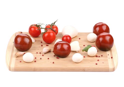 Tomatoes and mozzarella balls. Isolated on a white background.