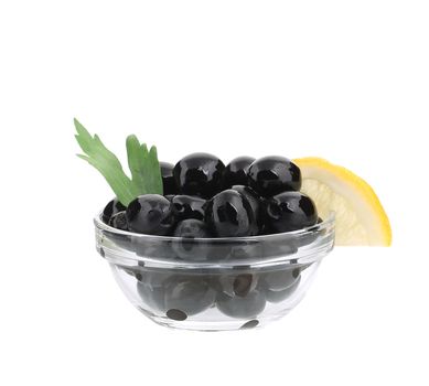 Black olives with lemon in bowl. Isolated on a white background.