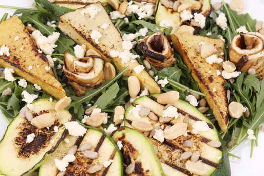 Salad with grilled vegetables and tofu. Whole background.