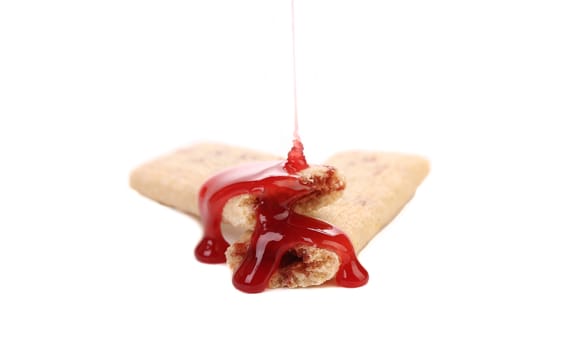 Strawberry syrup stream on stics of biscuit. Isolated on a white background.