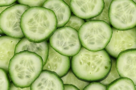 Close up fresh green sliced cucumber. Whole background.