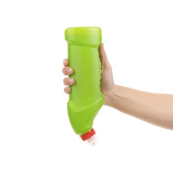 Hand holding green plastic bottle. Isolated on a white background.