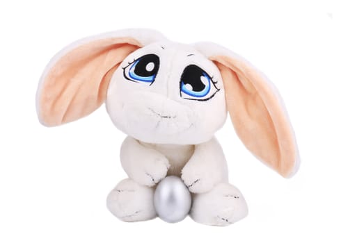 White easter toy rabbit with silver egg. Isolated on a white background.