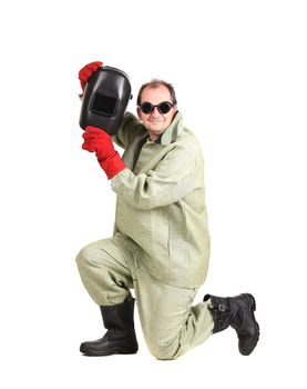Smiling worker holding welder mask. Isolated on a white background.