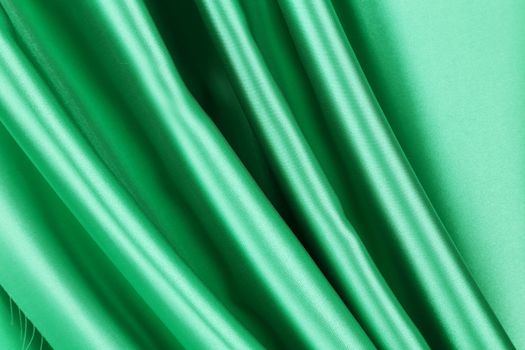 Green silk drapery. Close up. Whole background.