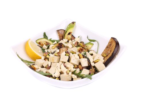 Salad with grilled vegetables and tofu. Isolated on a white background.