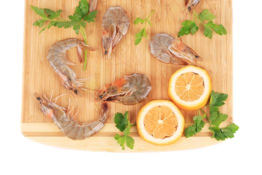 Fresh shrimps with parsley. Isolated on a white background.