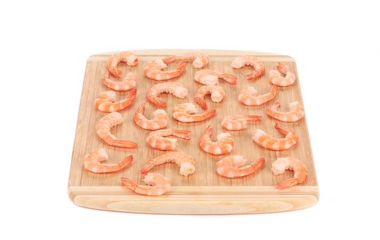 Boiled shrimps on cutting board. Isolated on a white background.