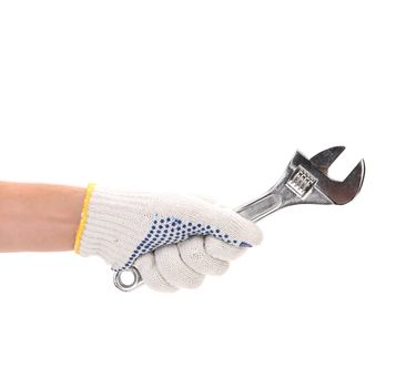 Hand in gloves holding adjustable wrench. Isolated on a white background.