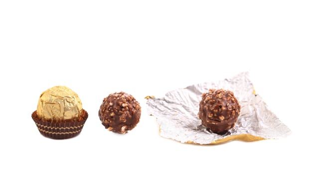 Three in row chocolate bonbons. Isolated on a white background.