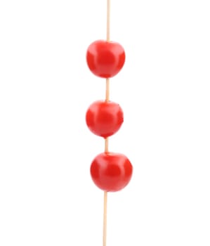 Three cherry tomatoes on stick. Isolated on a white background.