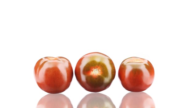 Close up of fresh three tomatoes. Isolated on a white background.