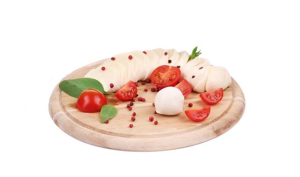 Tomatoes and mozzarella balls. Isolated on a white background.