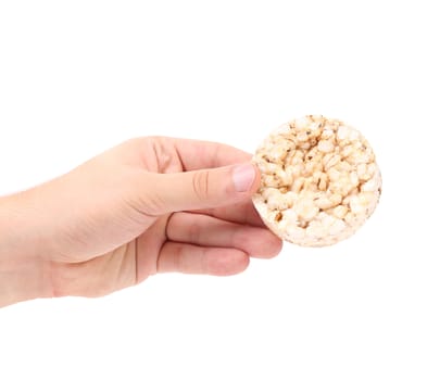 Puffed rice snack in hand. Isolated on a white background.