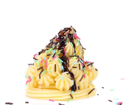 Cake topped with sprinkles. Isolated on a white background.