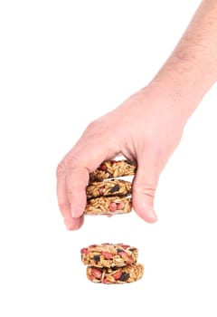 Hand holds candied peanuts sunflower seeds. Isolated on a white background.