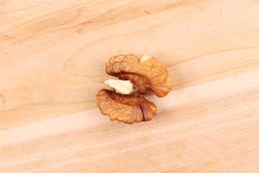 Walnut kernel on wooden background. Close up. Whole background.