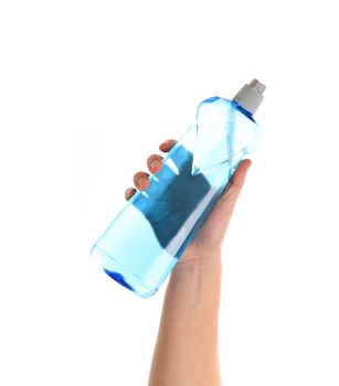 Blue bottle in a hand. Isolated on a white background.