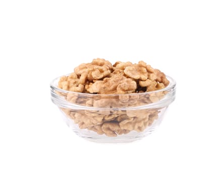 Glass bowl with walnuts. Isolated on a white background.