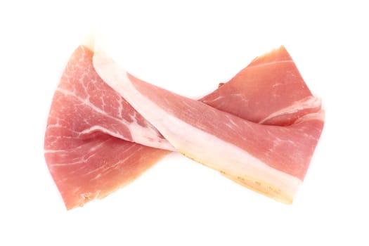 Slice of Delicious Prosciutto as Ribbon. Isolated on a white background.