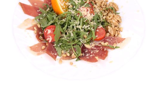 Salad with arugula and prosciutto. Whole background.