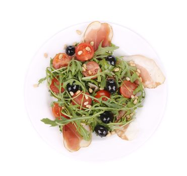 Salad with arugula and prosciutto. Isolated on a white background.