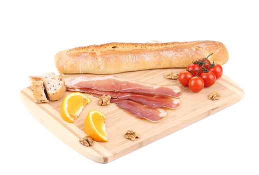 Prosciutto with cherry tomatoes and walnuts. Isolated on a white background.