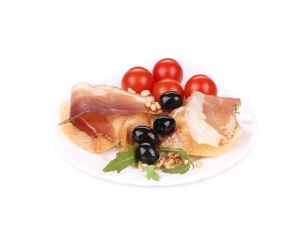 Salad with arugula and prosciutto. Isolated on a white background.