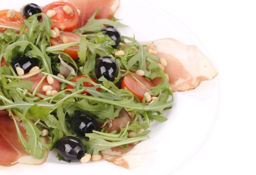 Salad with arugula and prosciutto. Whole background.