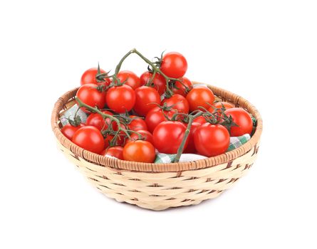 Wicker basket with cherry tomatoes. Isolated on a white background.