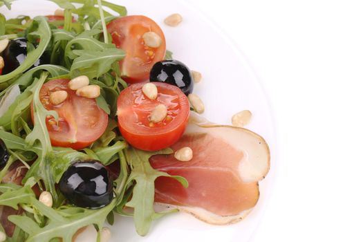 Salad with arugula and prosciutto. Whole background.