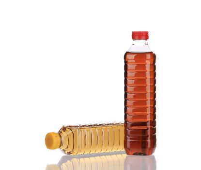 Two bottles of vinegar. Isolated on a white background.