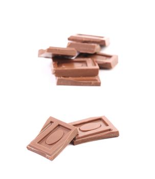 Tasty morsel of milk chocolate. Isolated on a white background.