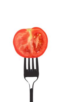 Red ripe tomato on fork. Isolated on a white background.