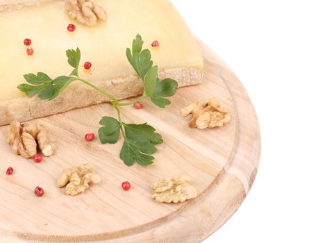 Parmesan cheese on platter with walnuts. Isolated on a white background.