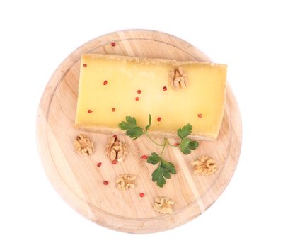 Parmesan cheese on platter with walnuts. Isolated on a white background.