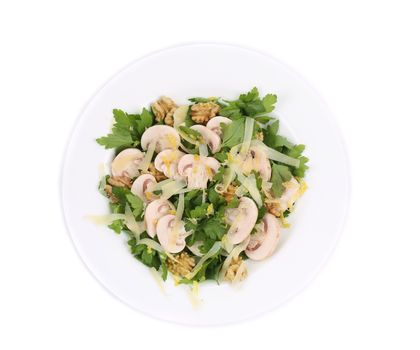 Mushroom salad with walnuts and parsley. Isolated on a white background.