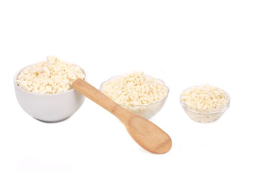 Cottage cheese in various bowls. Isolated on a white background.