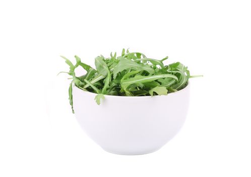 Fresh arugula in white bowl. Isolated on a white background.