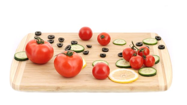 Vegetable composition on cutting board. Isolated on a white background.